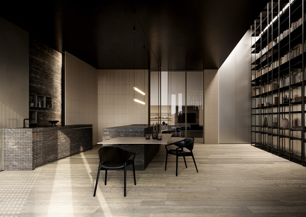 Cucina e living contemporaneo Cariolato con isola in pietra, libreria a parete, superfici materiche e illuminazione scenografica